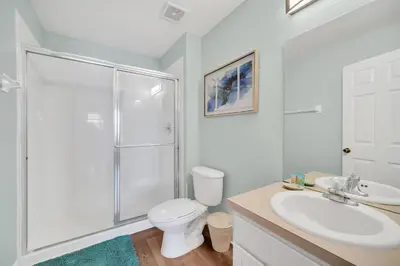 a bathroom with a shower and a toilet and a sink at Getaway Cove Villa in Orlando