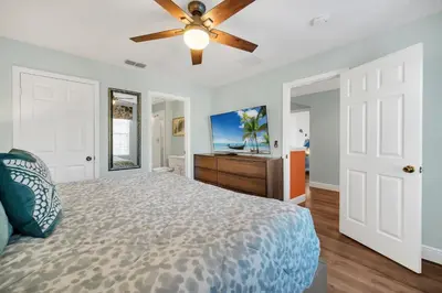 a bedroom with a bed and a ceiling fan at Getaway Cove Villa in Orlando