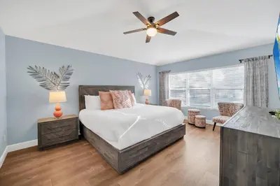 a bedroom with a bed and a ceiling fan at Getaway Cove Villa in Orlando