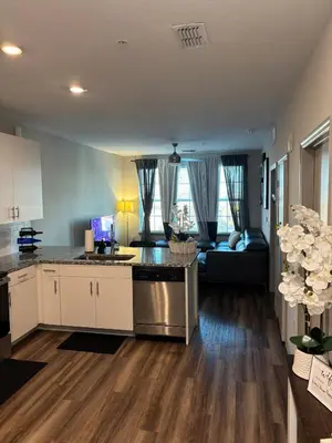 an open kitchen and living room with a couch at Carri-Vision Suite in Kissimmee