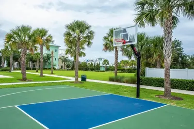 a basketball hoop on a tennis court with palm trees at Elegant 8BR Encore Resort Pool w Spa GameRoom Single Family in Orlando