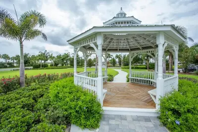 a gazebo in a park with a palm tree at Elegant 8BR Encore Resort Pool w Spa GameRoom Single Family in Orlando