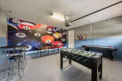 a ping pong table in a room with two tables at Elegant 8BR Encore Resort Pool w Spa GameRoom Single Family in Orlando