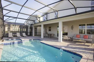 an indoor swimming pool with a glass ceiling at Epic Dream Home with Spa Game Room Themed Bedrooms 2887 Single Family in Kissimmee