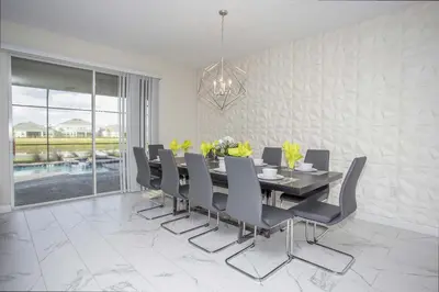 a dining room with a table and chairs at Epic Dream Home with Spa Game Room Themed Bedrooms 2887 Single Family in Kissimmee