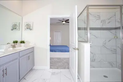 a bathroom with a shower and a sink and a tub at Epic Dream Home with Spa Game Room Themed Bedrooms 2887 Single Family in Kissimmee
