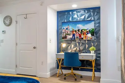 a room with a desk and a painting on the wall at Luxury Lakeview Getaway 1 mile Universal Studios in Orlando