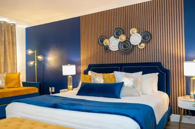 a blue bedroom with a bed with blue and yellow walls at Luxury Lakeview Getaway 1 mile Universal Studios in Orlando