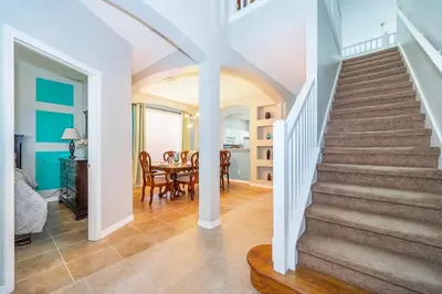 a staircase in a home with a dining room at Vacation Villa Near Disney With Private Pool Spa in Kissimmee