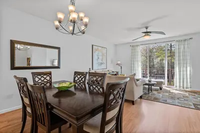 a dining room and living room with a table and chairs at Comfortable 3BR Near Convention Center & Epic Park in Orlando