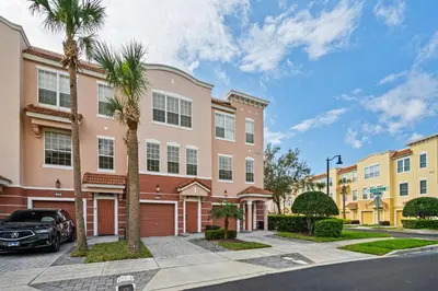 a car parked in front of a building with palm trees at Comfortable 3BR Near Convention Center & Epic Park in Orlando