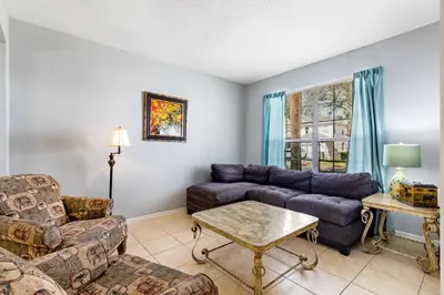 a living room with a couch and a table at Disney Doorstep 7 Bedroom Villa with SouthFacing Pool and Hot Tub in Kissimmee
