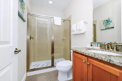 a bathroom with a shower and a toilet and a sink at Welcoming Home With Game Room And Private Pool With Water Park Access At Encore Resorts Reunion - 150Mn in Kissimmee