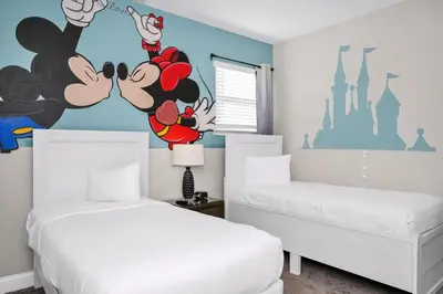 two beds in a bedroom with a mickey mouse mural at Marvelous Home With Media Room, Theme Room And Waterpark & Resort Access Near Disney At Encore Resorts Reunion - 7485Mr in Kissimmee