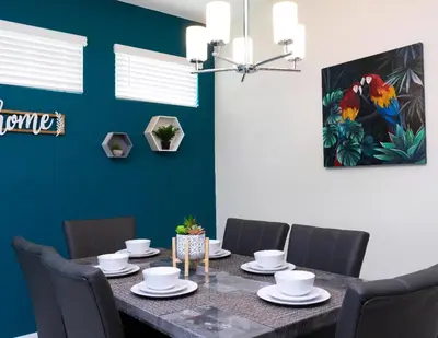 a dining room with a table and chairs at Amazing Townhome With Lake View At Storey Lake Resort in Kissimmee