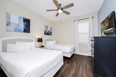 a bedroom with two beds and a ceiling fan at Extravagant Home With Movie Theater, Private Pool And Waterpark & Resort Access At Encore Resort - 241Fl in Kissimmee