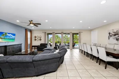 a living room with couches and a dining room at Extravagant Home With Movie Theater, Private Pool And Waterpark & Resort Access At Encore Resort - 241Fl in Kissimmee