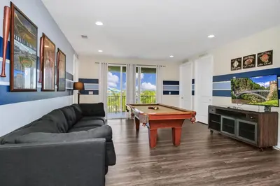 a living room with a couch and a pool table at Extravagant Home With Movie Theater, Private Pool And Waterpark & Resort Access At Encore Resort - 241Fl in Kissimmee