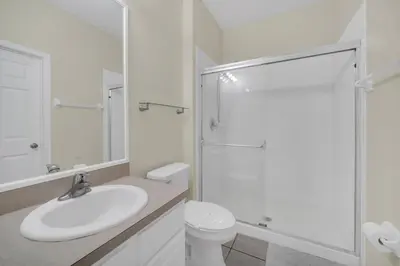 a white bathroom with a sink and a shower at Perfect Townhome Near Disney in Orlando