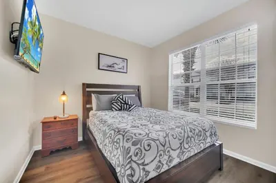 a bedroom with a bed and a window at Perfect Townhome Near Disney in Orlando