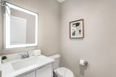 a white bathroom with a sink and a mirror at Cozy home in the best location of orlando in Kissimmee