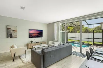a living room with a couch and a pool at Cozy home in the best location of orlando in Kissimmee