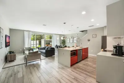 a living room with a kitchen and a living room with a couch at Cozy home in the best location of orlando in Kissimmee