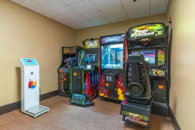 a room with three video game machines in a room at Spacious 1BR near Universal I-Drive in Orlando