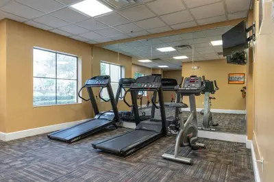 a gym with treadmills and ellipticals in a room at Spacious 1BR near Universal I-Drive in Orlando
