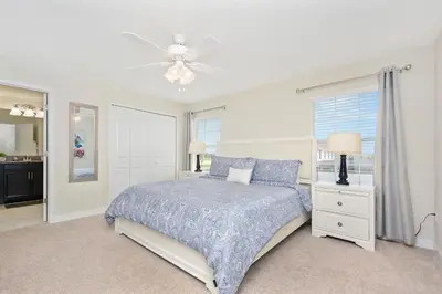 a bedroom with a bed and a ceiling fan at Wonderful 4Bd with Pool at Storey Lake Resort 4819 in Kissimmee