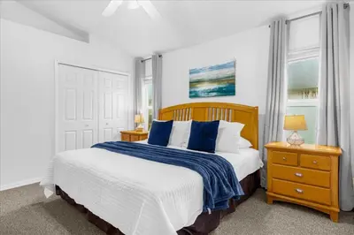 a bedroom with a large bed with blue pillows at Cozy 5BR Near Disney Mickey Pool in Kissimmee