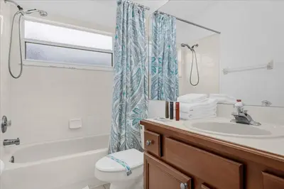 a bathroom with a sink and a toilet and a shower at Cozy 5BR Near Disney Mickey Pool in Kissimmee