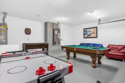 a living room with a pool table and a couch at Cozy 5BR Near Disney Mickey Pool in Kissimmee