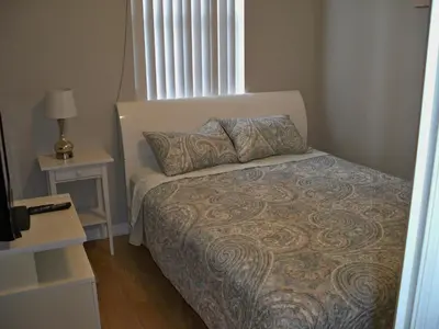 a small bedroom with a bed and a window at Lovely Vacation Home with 3 bedrooms! in Kissimmee