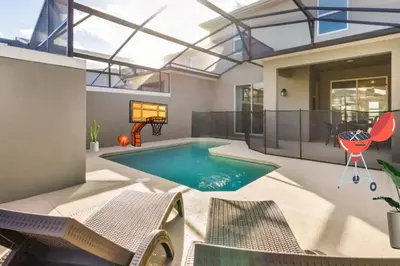 a swimming pool in a house with a glass ceiling at NEW King Bed Disney Contemporary Townhouse in Kissimmee