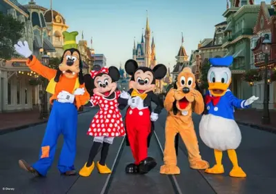 a group of mickeys dressed in costumes in front of the disney at NEW King Bed Disney Contemporary Townhouse in Kissimmee