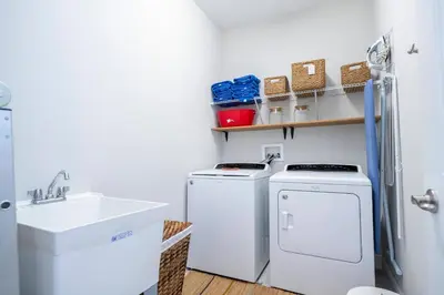 a laundry room with a washer and dryer and a sink at Fantastic 5BR Villa Near Disney - Priv. Pool SPA in Orlando