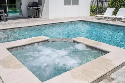 a large swimming pool with aitatingfficient at Fantastic 5BR Villa Near Disney - Priv. Pool SPA in Orlando