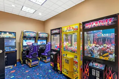 a room with arcade games and video game machines at King Bed Theme Park Hotel Free Shuttle Included in Orlando