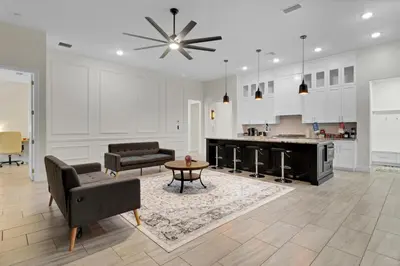a living room with a couch and a table at SpaceX BY R3 Shared Bath in Orlando