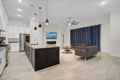 a kitchen and living room with a couch and a table at SpaceX BY R5 Shared Bath in Orlando