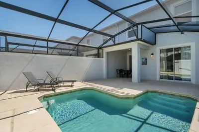a swimming pool in the middle of a house at Stylish 4BR home Near Disney with Themed Rooms in Kissimmee