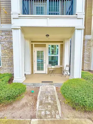 a front porch of a house with two chairs at Modern Apt in Lake Nona, 10min to ORL Airport in Orlando