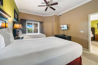 a bedroom with a large white bed and a window at Villas North Charm in Orlando