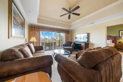 a living room with two couches and a ceiling fan at Villas North Charm in Orlando