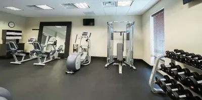 a gym with treadmills and ellipticals in a room at Hampton Inn & Suites Orlando near SeaWorld in Orlando