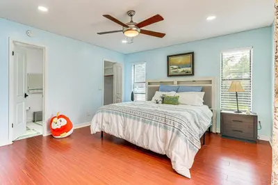 a bedroom with a bed and a ceiling fan at Swim, Golf and Relax Lovely Home in Lake Mary in Lake Mary