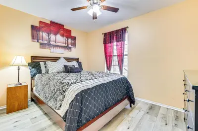 a bedroom with a bed and a ceiling fan at Swim, Golf and Relax Lovely Home in Lake Mary in Lake Mary