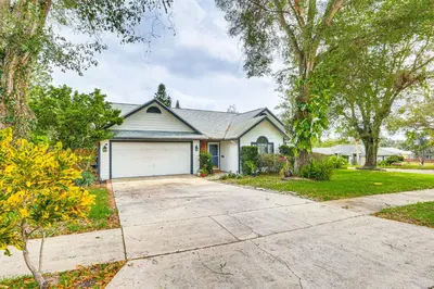 a house with a driveway and a garage at Swim, Golf and Relax Lovely Home in Lake Mary in Lake Mary