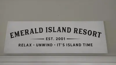 a sign that reads emerald island resort on a wall at Spectacular Lake View - Game Room- Close to Disney in Kissimmee